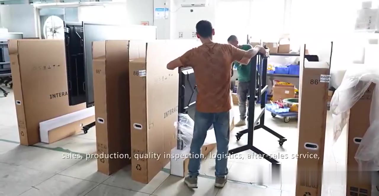 workers packing interactive displays into export cartons for shipping