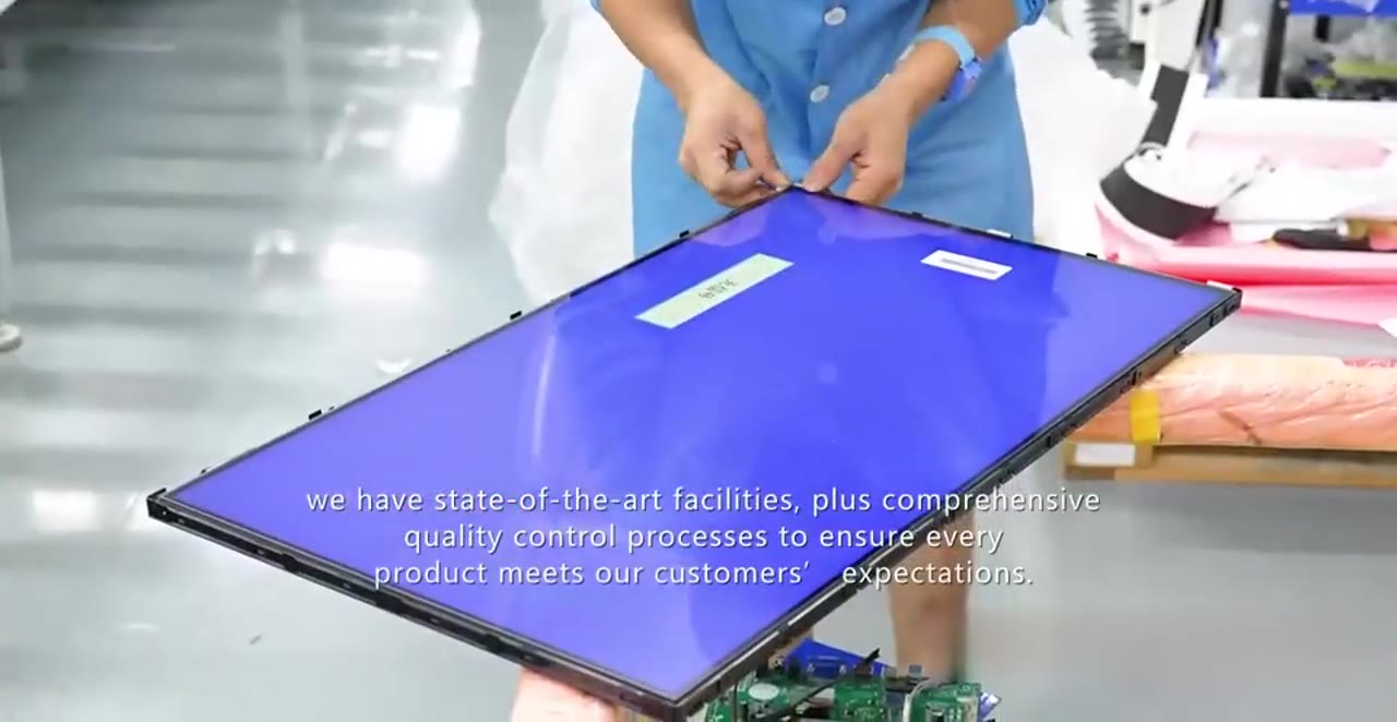 worker handling display panel during sample production